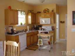 Kitchen with built-in microwave, pantry, and oak cabinets. Other