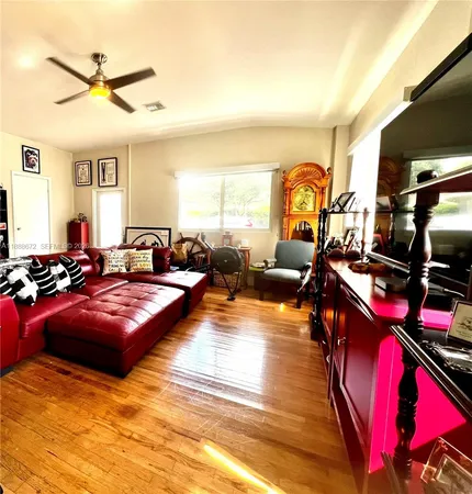 a living room with furniture fireplace and a large window