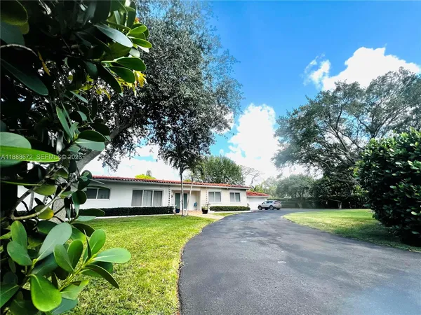 a front view of house with yard and green space