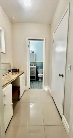 a view of a kitchen from the hallway