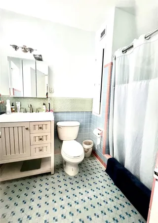 a bathroom with a sink a toilet and a shower