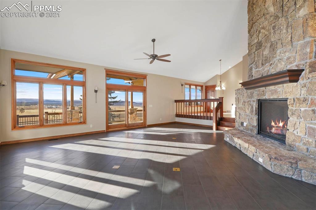 Undisclosed Address Larkspur, CO 80118 - Photo 4 of 39 a spacious bedroom with a bed and a fireplace