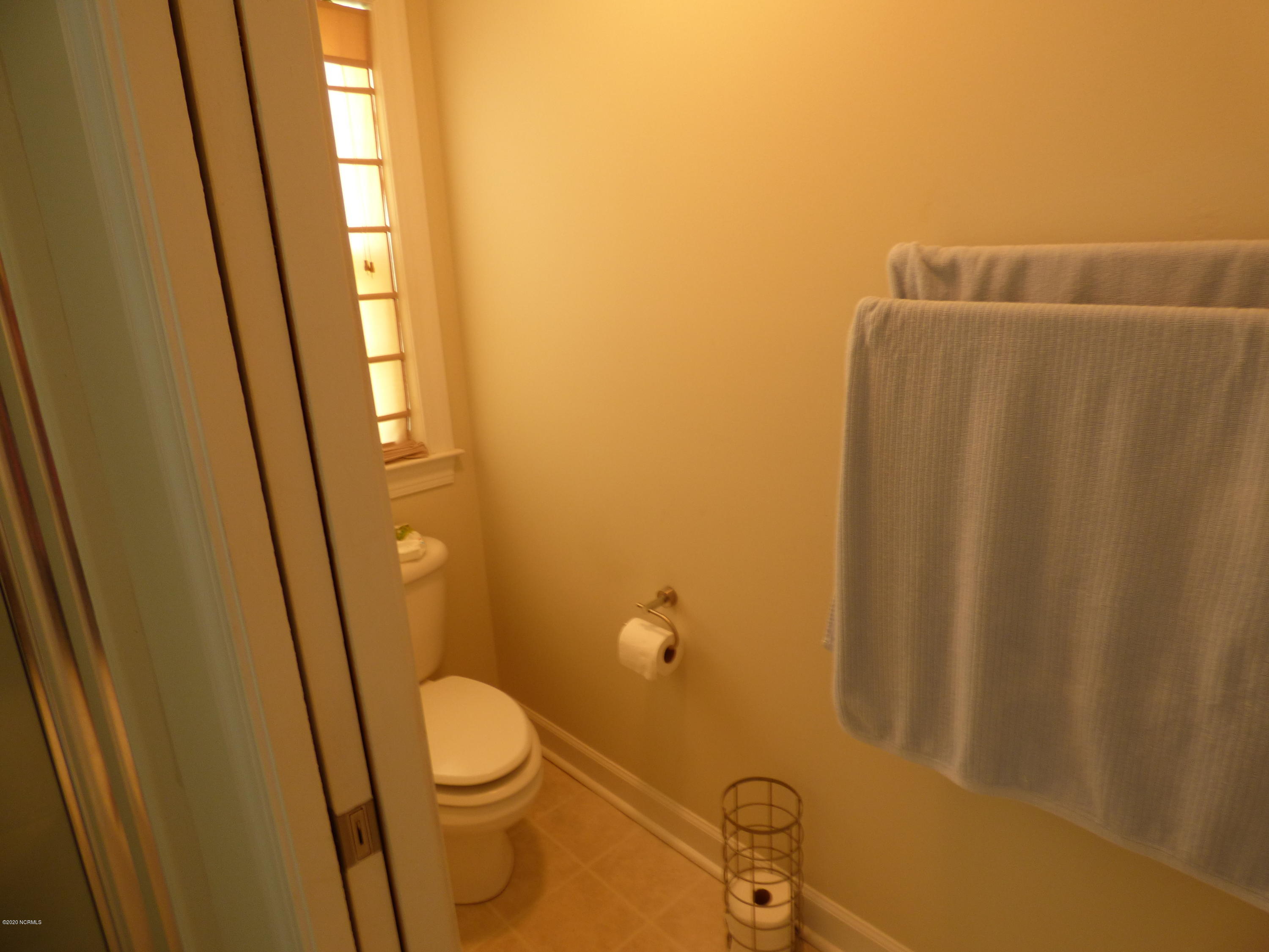 67 Cedar Tree Lane Southwest Calabash, NC 28467 - Photo 16 of 39 master water closet with pocket door