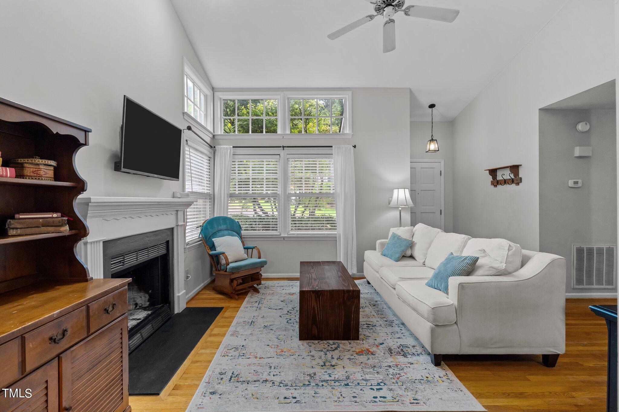 4416 Timberhurst Drive Raleigh, NC 27612 - Photo 6 of 39 a living room with furniture fireplace and a flat screen tv