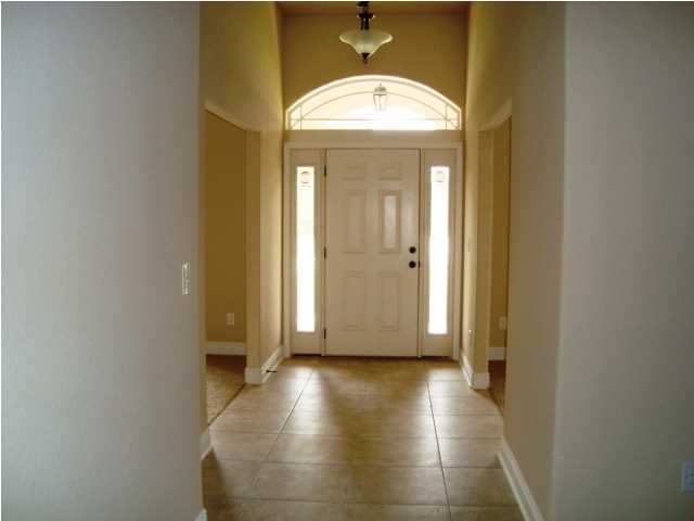 3056 Wallace Lake Road Pace, FL 32571 - Photo 14 of 19 a view of a hallway with wooden floor