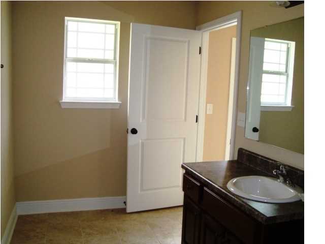 3056 Wallace Lake Road Pace, FL 32571 - Photo 18 of 19 a bathroom with a granite countertop sink a mirror and a window