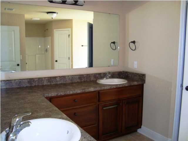 3056 Wallace Lake Road Pace, FL 32571 - Photo 8 of 19 a bathroom with a granite countertop sink and a mirror
