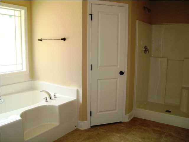 3056 Wallace Lake Road Pace, FL 32571 - Photo 10 of 19 a bathroom with a bathtub and shower