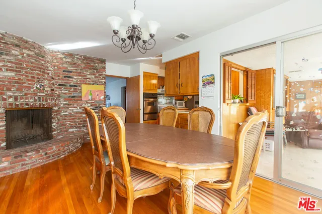 a large kitchen with stainless steel appliances a sink and cabinets