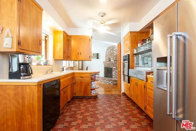 a kitchen with stainless steel appliances a refrigerator and a stove