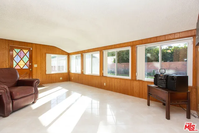 a bedroom with furniture and a large window