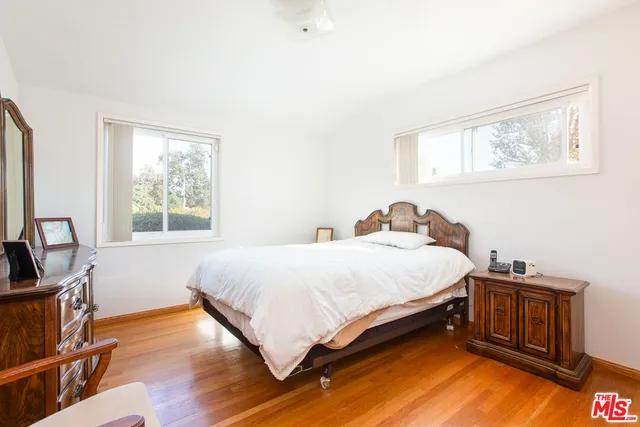 a bedroom with a large bed and a large window