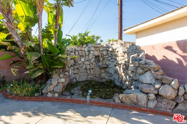 an aerial view of a house with garden space and street view
