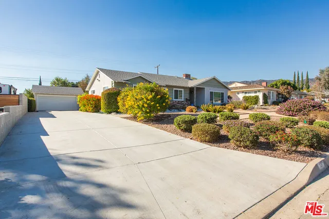 a view of a house with large trees
