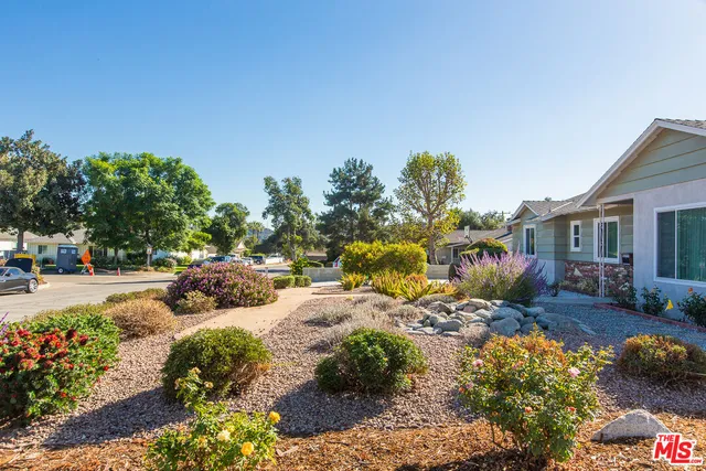 a row of cars parked in front of a house