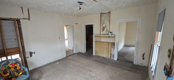 an aerial view of residential house with parking and trees