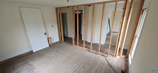 a view of staircase with wooden floor and window