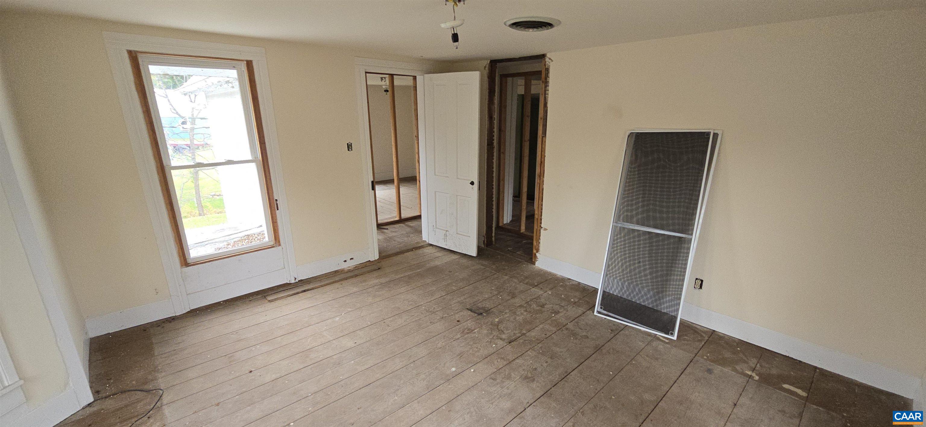 276 Main Street Stanardsville, VA 22973 - Photo 19 of 38 an empty room with windows and closet