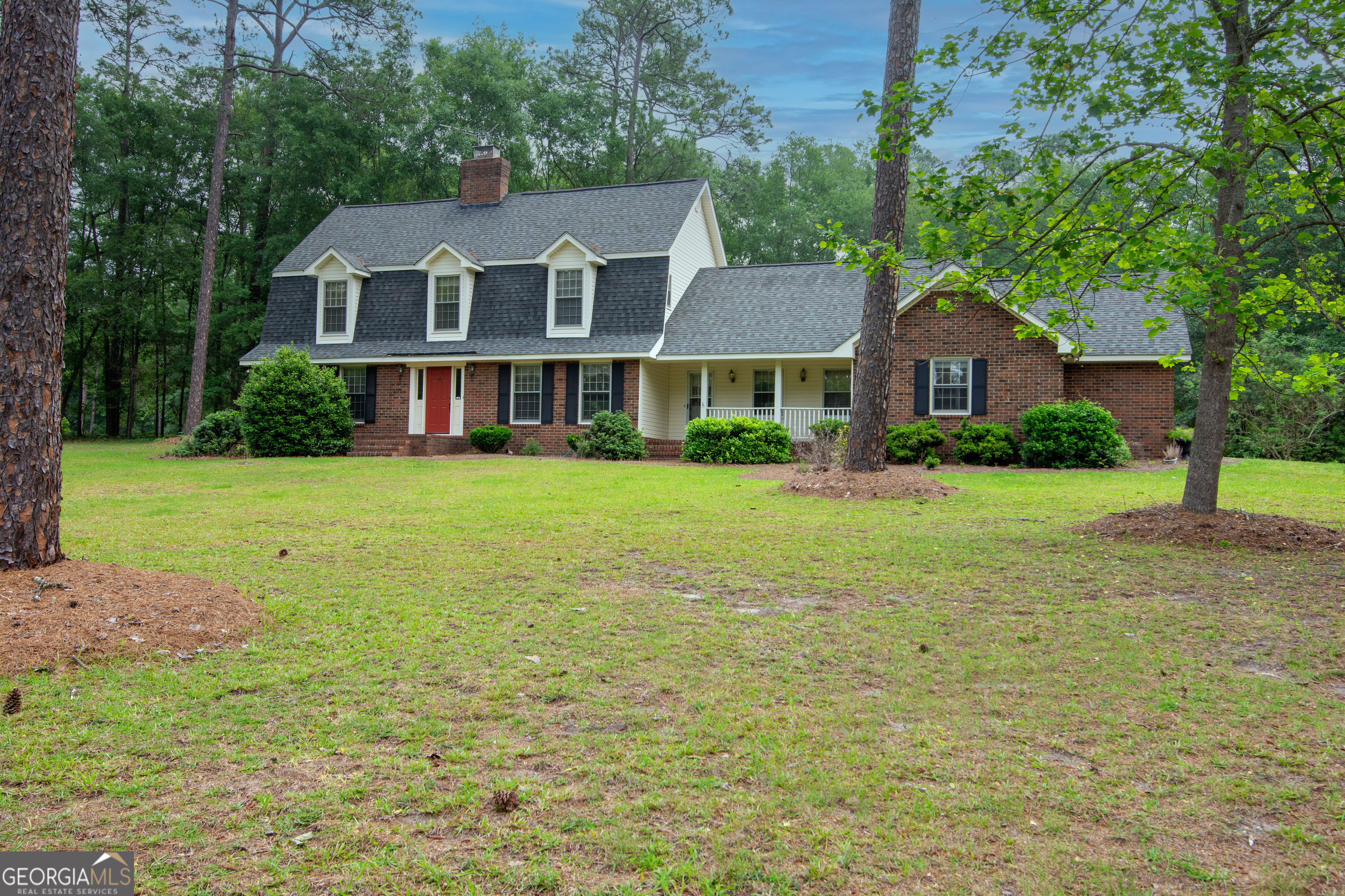 a front view of a house with yard and green space