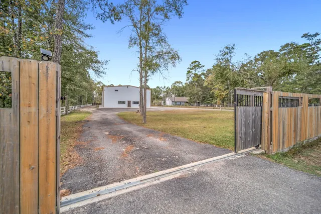 a view of a yard with wooden fence
