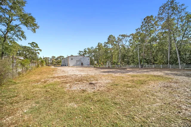 a view of a big yard with trees