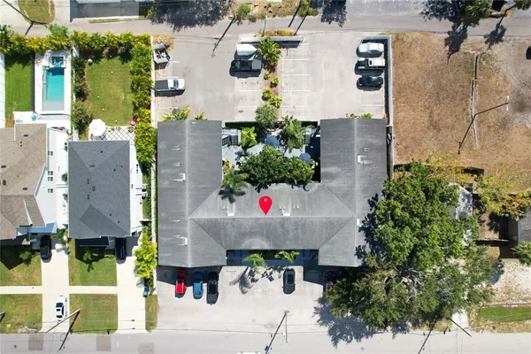 an aerial view of a house with outdoor space and seating area