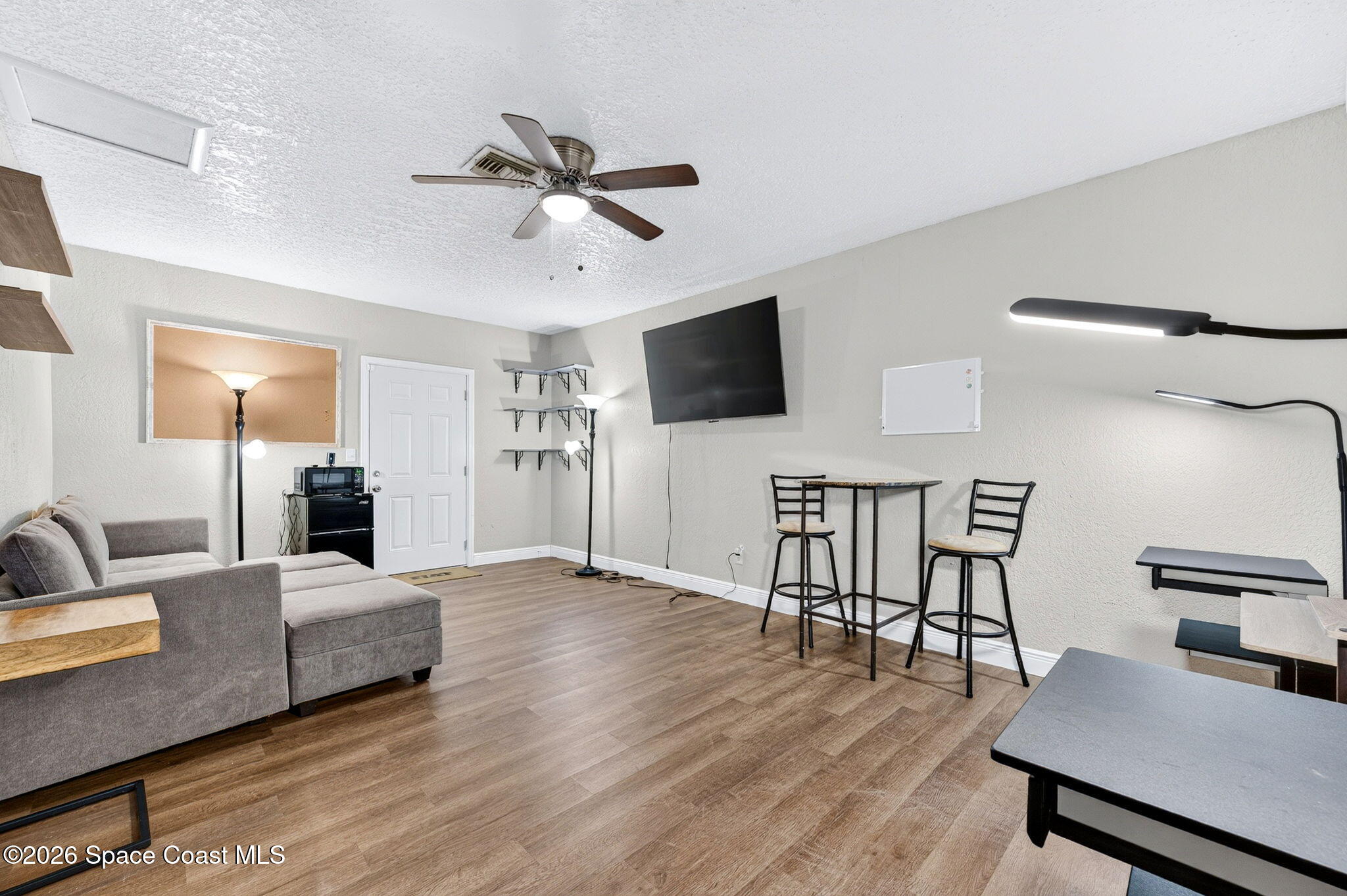 996 Botany Lane Rockledge, FL 32955 - Photo 17 of 35 a living room with furniture and a flat screen tv