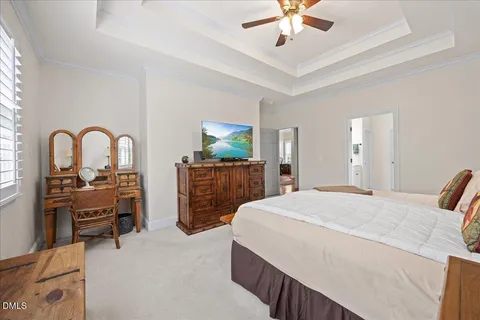 a spacious bedroom with a bed and a chandelier