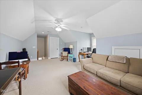 a living room with furniture and a gym machine