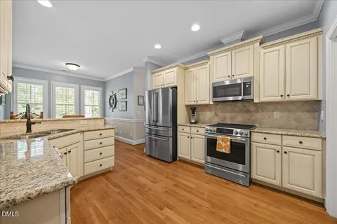 a view of a hallway view with wooden floor and windows