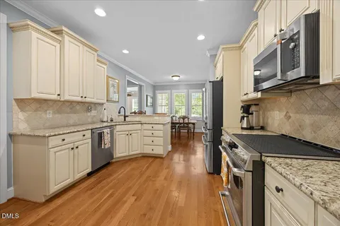 a kitchen with stainless steel appliances a stove sink and refrigerator