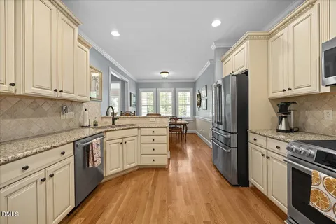 a kitchen with a stove a sink and a refrigerator