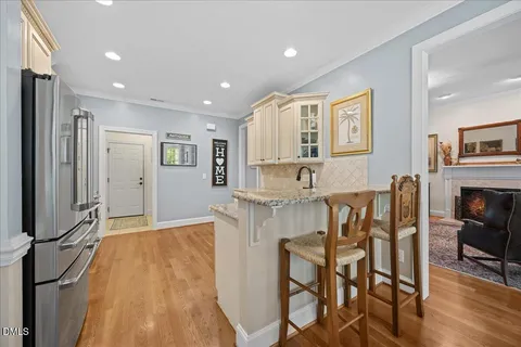 a view of a a dining room with furniture window and wooden floor