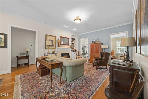 a living room with furniture a fireplace and wooden floor