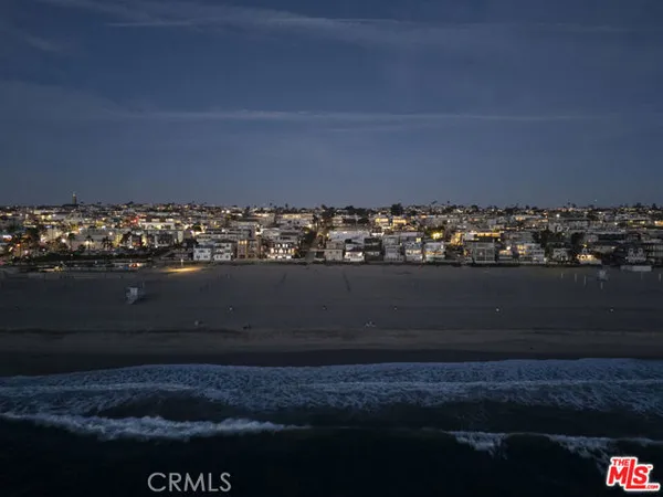 a living room with furniture fireplace and a large window