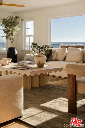 a living room with furniture a flat screen tv and a table