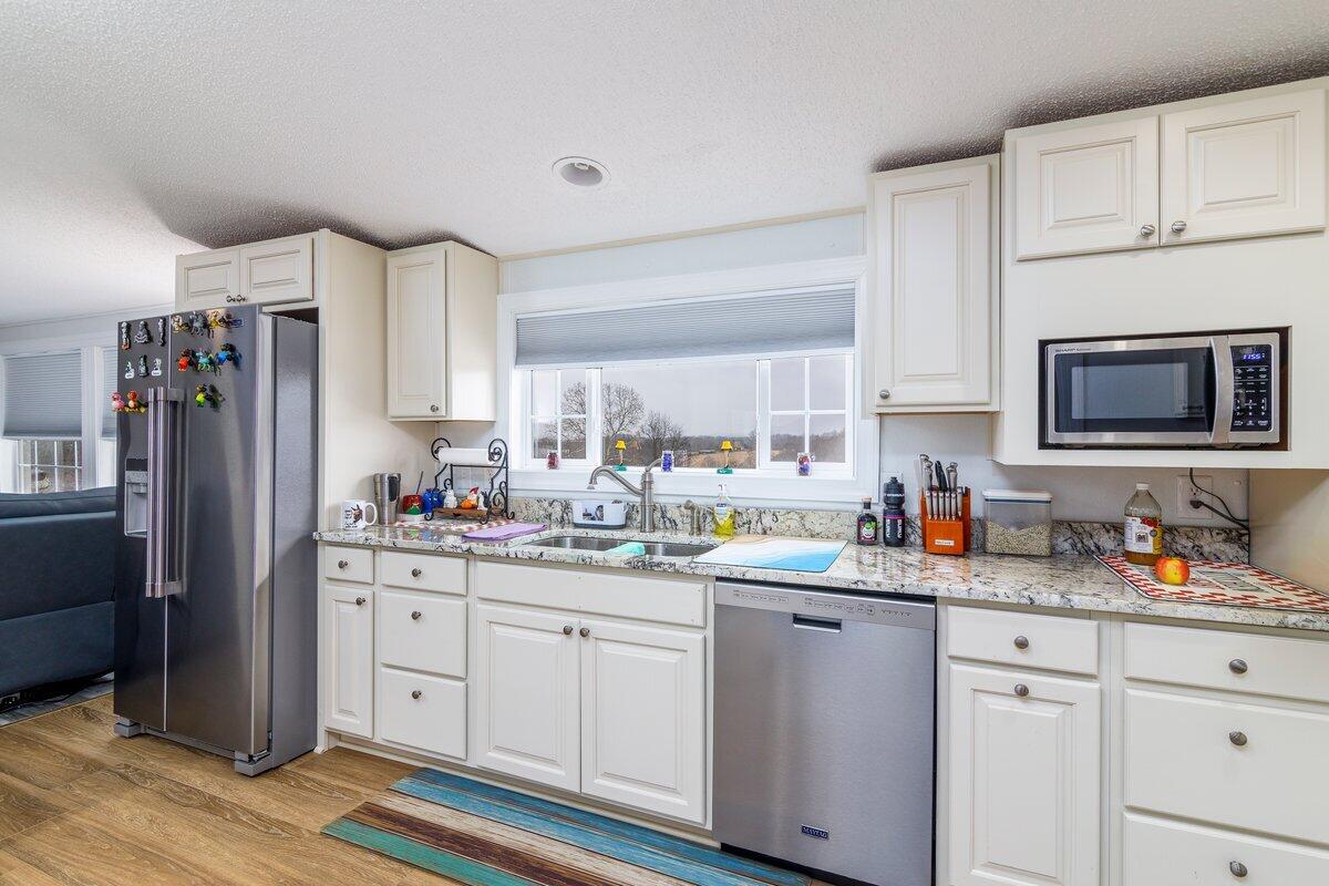 652 Marcus-823 Road Rocky Mount, VA 24151 - Photo 11 of 34 a kitchen with stainless steel appliances a sink stove refrigerator and cabinets