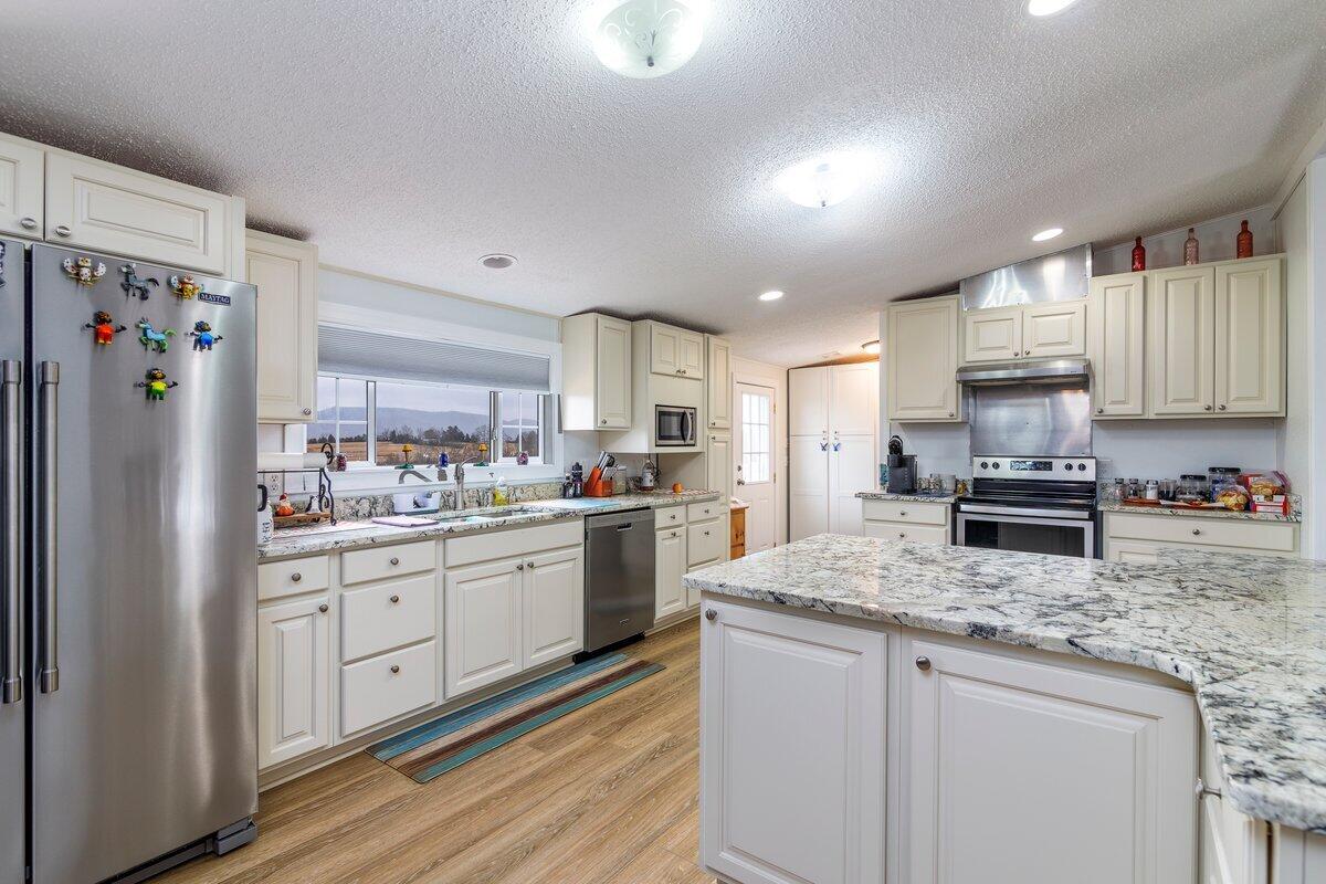 652 Marcus-823 Road Rocky Mount, VA 24151 - Photo 12 of 34 a kitchen with granite countertop cabinets stainless steel appliances and a counter space