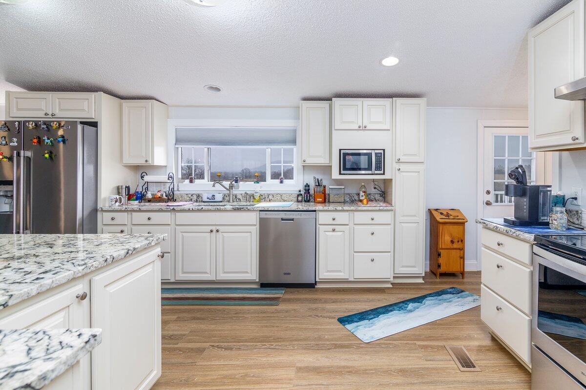 652 Marcus-823 Road Rocky Mount, VA 24151 - Photo 8 of 34 a kitchen with white cabinets and stainless steel appliances
