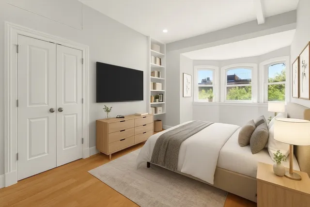 a bedroom with a bed and flat screen tv