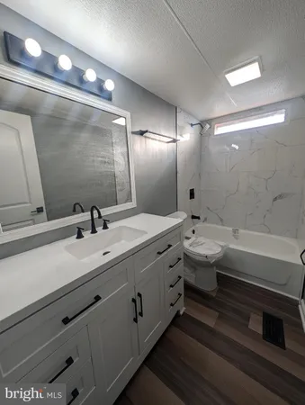 a bathroom with double vanity and a mirror