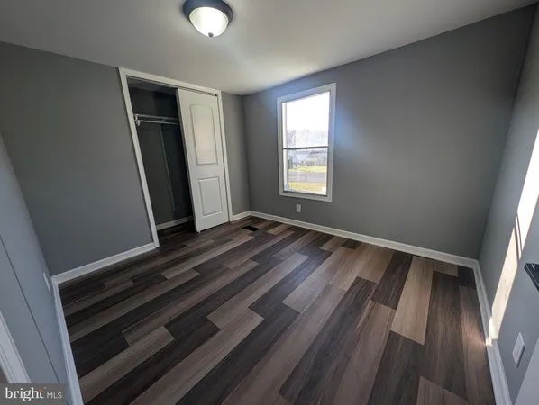 a view of room with window and hardwood floor
