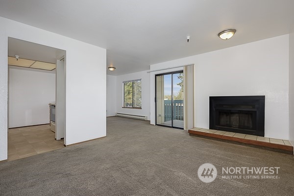 409 Southwest 155th Street Burien, WA 98166 - Photo 13 of 22 a view of an empty room with a fireplace and a window