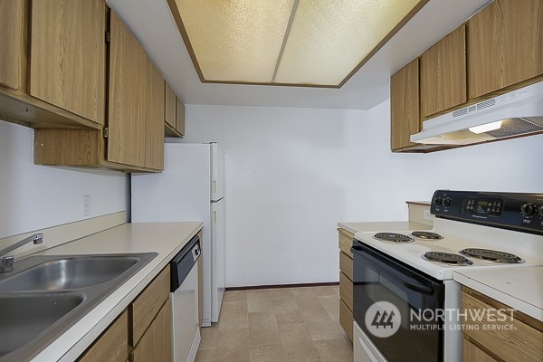 409 Southwest 155th Street Burien, WA 98166 - Photo 16 of 22 a kitchen with a stove and a sink