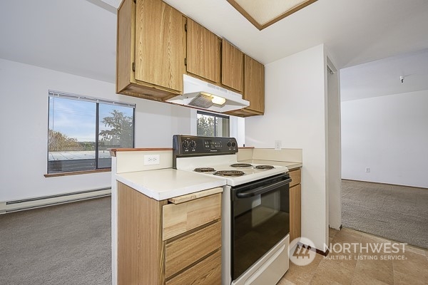 409 Southwest 155th Street Burien, WA 98166 - Photo 17 of 22 a kitchen with a stove and a microwave