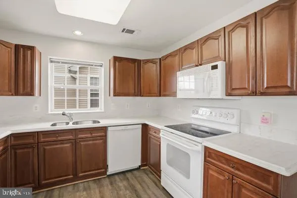 a kitchen with stainless steel appliances a sink stove and cabinets