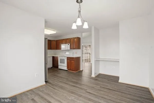 a view of a kitchen with a sink and a wooden floor
