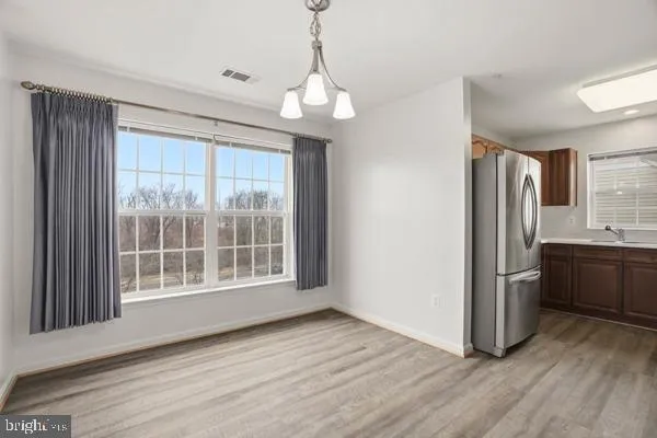 a view of wooden floor and a kitchen