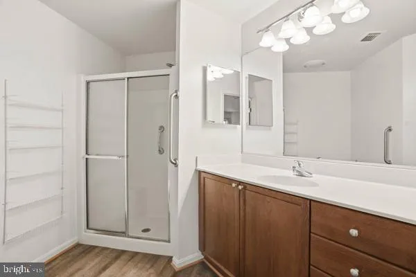 a bathroom with a sink vanity and a mirror