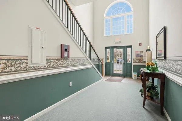 a view of an entryway with wooden floor and a livingroom